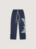 Godspeed New York OG Logo Sweatpants Navy V2 with white text graphic on one of the legs, and white drawstrings, front view Godspeed New York OG Logo Sweatpants V2 - Image 2 | Authenticated at Pieces Los Angeles