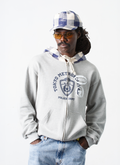Man wearing the Pieces TKYPD Plaid Hooded Zip Up Sweatshirt Heather Grey with checkered blue white hood, front view with the Pieces Street Hat Cream Navy Plaid Pieces TKYPD Plaid Hooded Zip Up Sweatshirt Heather Grey - Image 3 | Authenticated at Pieces Los Angeles