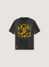 Amiri Track Tee shirt Washed Black with yellow text and graphic front view 