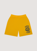 Denim Tears Denim University Mesh Shorts Yellow with Denim Tears text and wraith logo, front view Denim Tears Denim University Mesh Shorts Yellow - Image 1 | Authenticated at Pieces Los Angeles