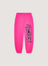 Sp5der Worldwide Punk V2 Sweatpants Magenta Pink with black text and little yellow stars, front view