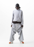 Man wearing the Pieces Wired Sweatshirt Heather Grey hoodie with small P star logo and three wired stripes going down the sleeves like Adidas, with grey sweatpants, full body shot, front view Pieces Wired Sweatshirt Heather Grey - Image 4 | Authenticated at Pieces Los Angeles